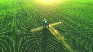 aerial-drone-tractor-spraying-corn-field